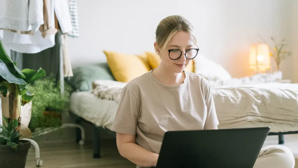 Independent worker in glasses working on a laptop from home